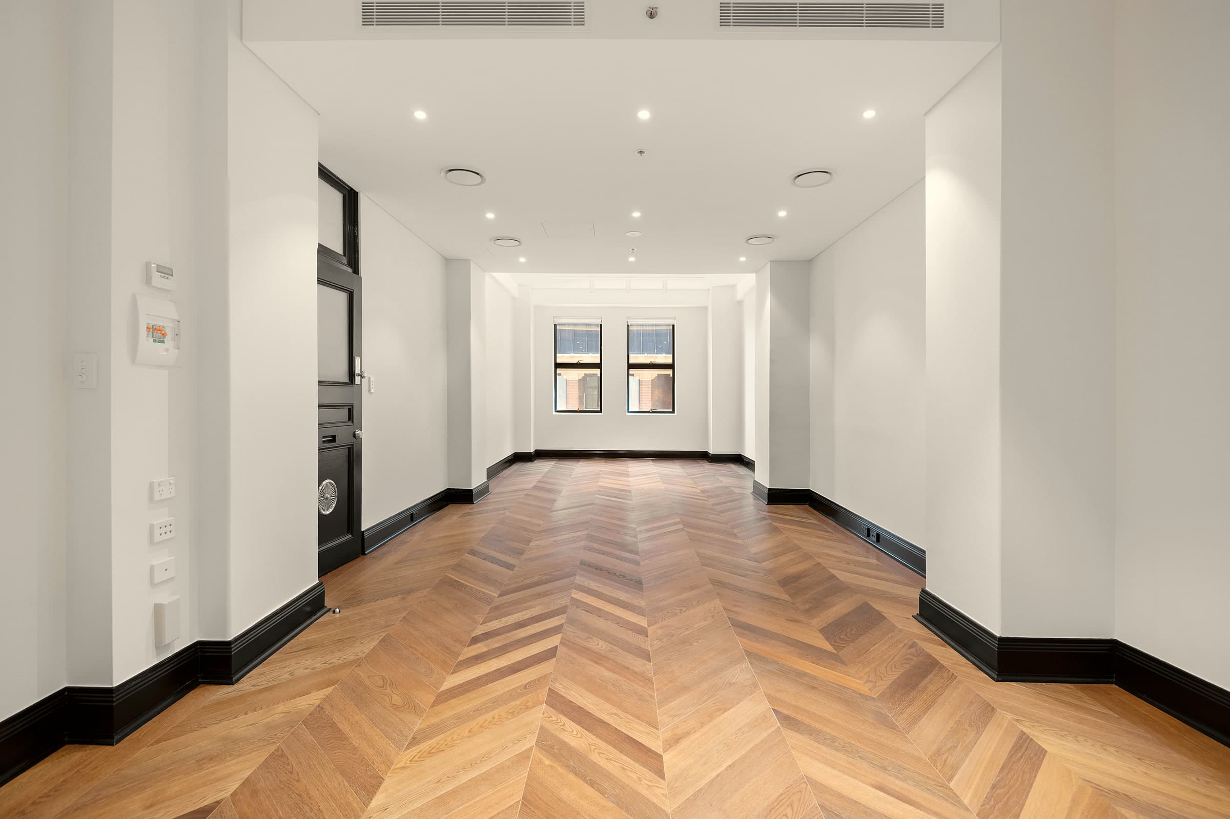 Meeting room with herringbone timber floors and tall windows